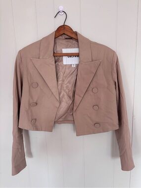 GRLFRND Power Crop is a short, double-breasted blazer in a pinkish khaki tone.